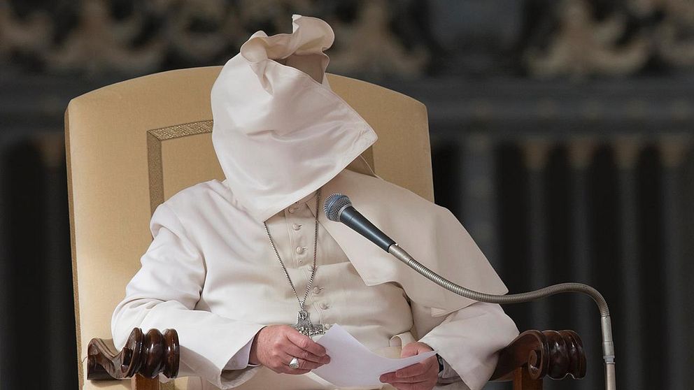 A gust of wind blows Pope Francis' mantle as he reads his speech during his weekly general audience in St. Peter's Square at the Vatican, Wednesday, Feb. 19, 2014