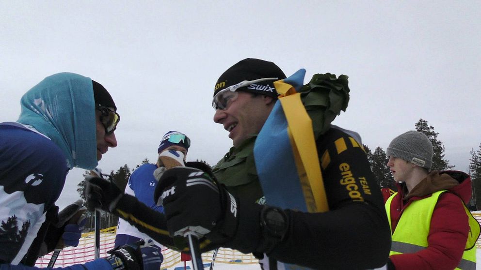två skidåkare, ettan och tvåan i långloppet, möts efter mållinjen