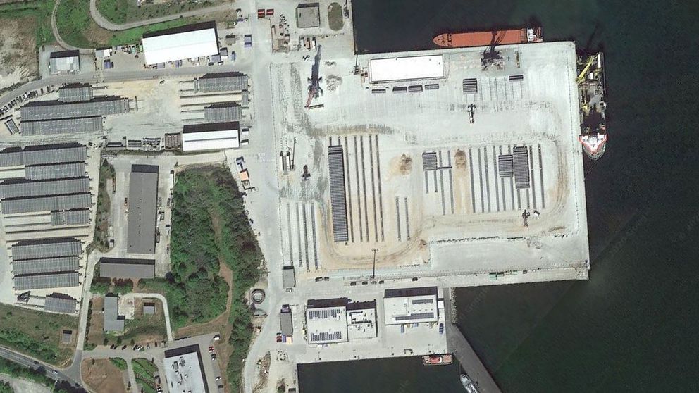 Satellitbild av tyska hamnen Mukran i Sassnitz i Östersjön. Arbetsfartyg ligger vid kaj intill lagrade rör.