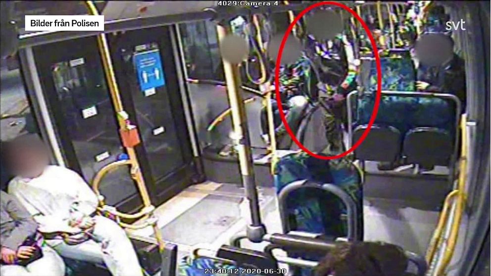 Övervakningsbild från en buss där en man som står i mittgången är inringad i rött.