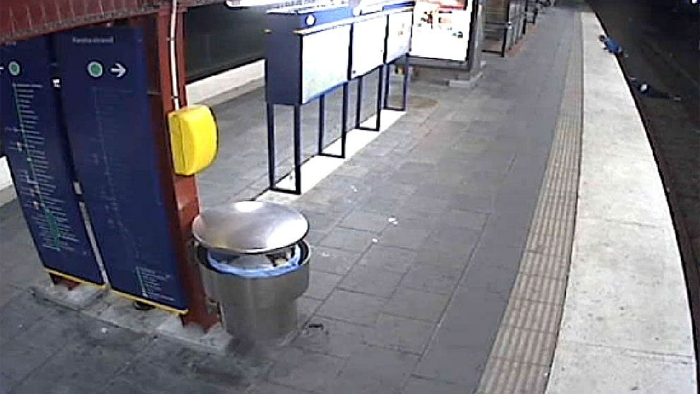 I stället för att hjälpa en man som låg medvetslös på tunnelbanespåret i Sandsborg valde en förbipasserande att råna honom på mobil, plånbok och guldkedja och gå därifrån. Foto: SL:s övervakningskamera