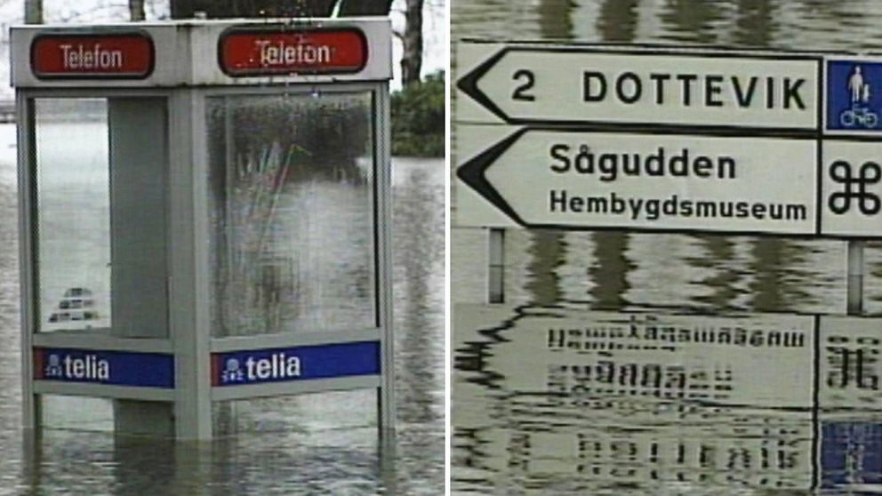 En telefonkiosk till hälften täckt av vatten samt en vägskylt som pekar mot Dottevik och Sågudden, också den med vatten en bra bit upp.