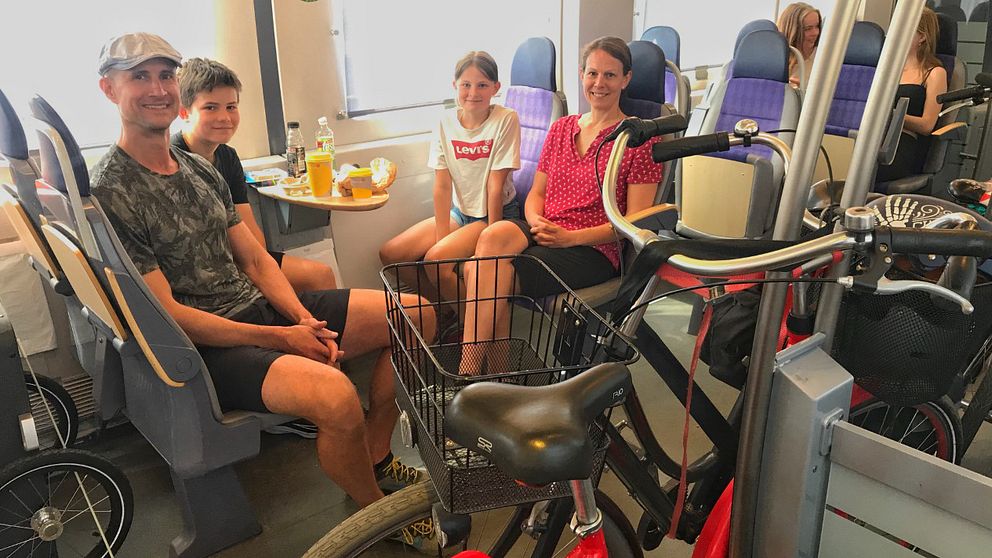 Familjen Woodworth sitter på tåget, med sina cyklar.