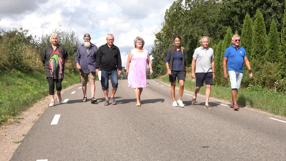 Sju personer som är engagerade i namninsamlingen går längs väg 1560 utanför Tryde.