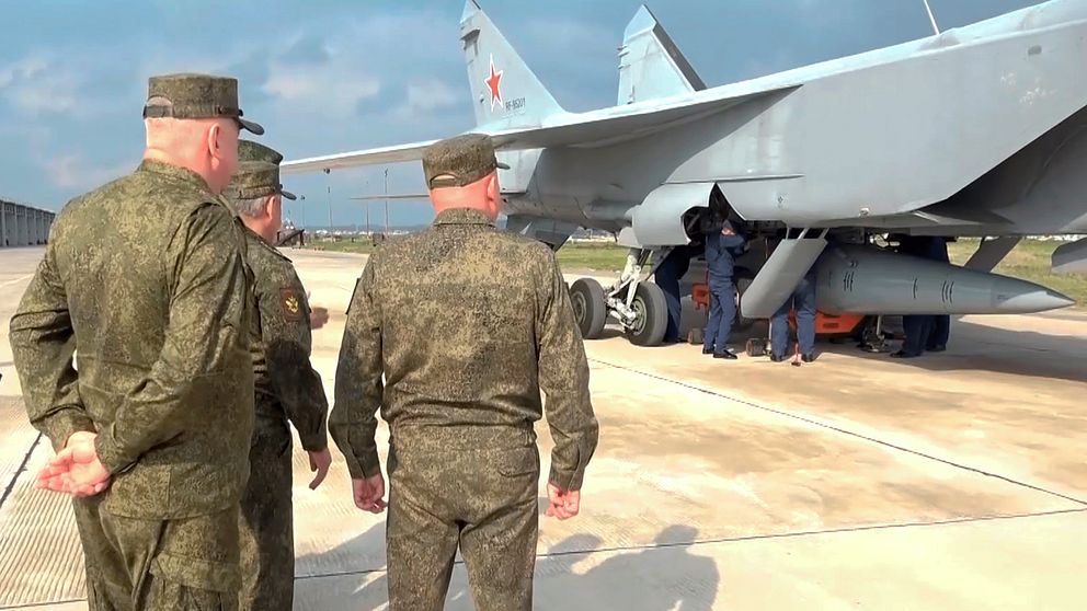 Rysslands försvarsminister Sergej Shoigu och två andra höga officerare inspekterar ett ryskt Mig-31 stridsflygplan som beväpnats med Kinzjal, en hypersonisk robot.