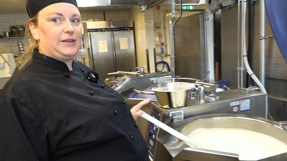 Kocken Camilla Lundblad står och rör i en gryta med någon slags gröt i.