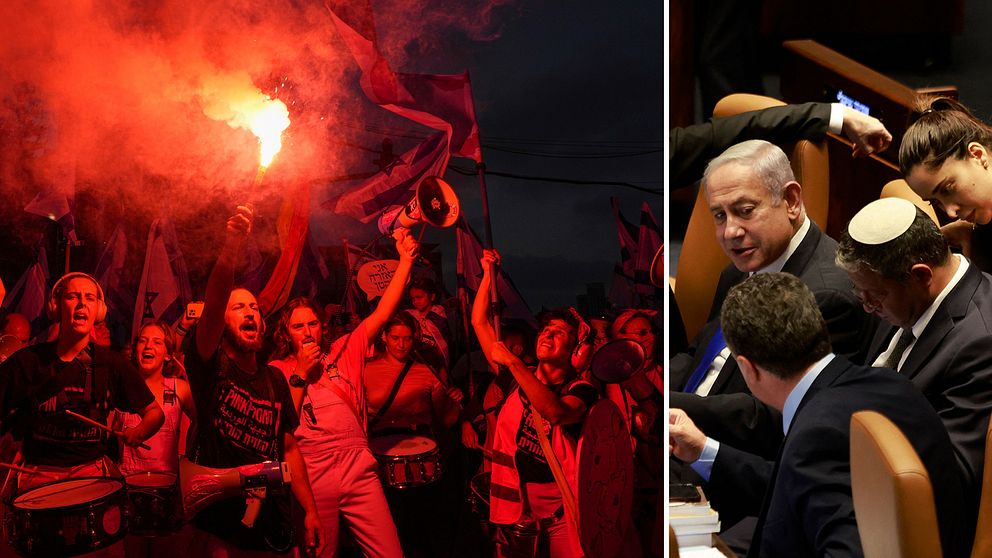 Demonstranter höjer flaggor, facklor och bengaler och rött ljus lyser upp dem i mörkret.