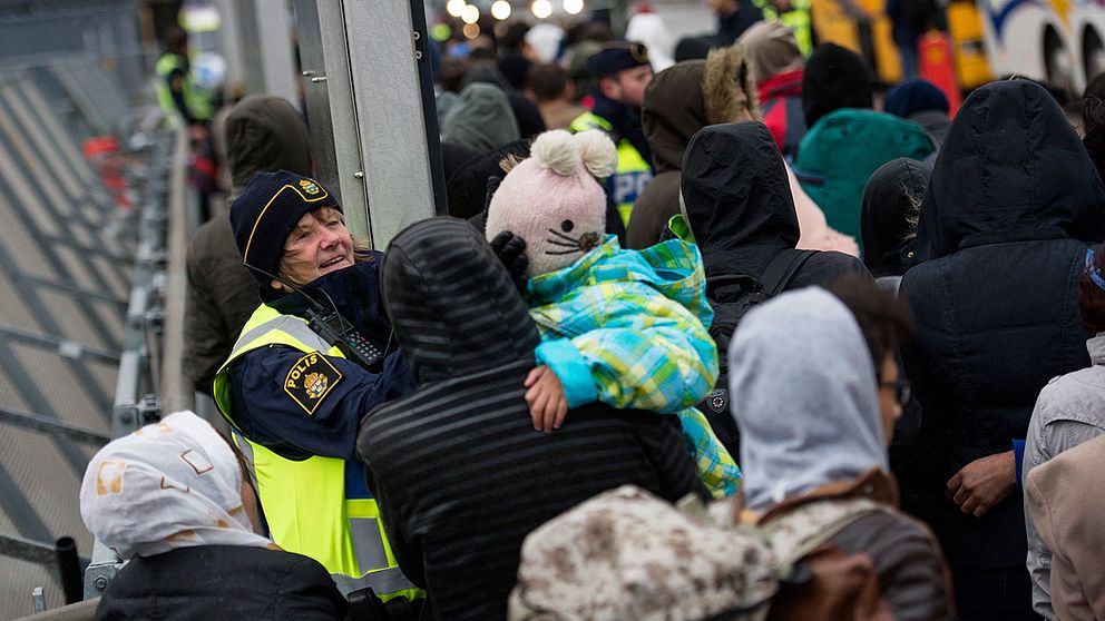 Poliser tar emot asylsökande vid Hyllie station utanför Malmö.