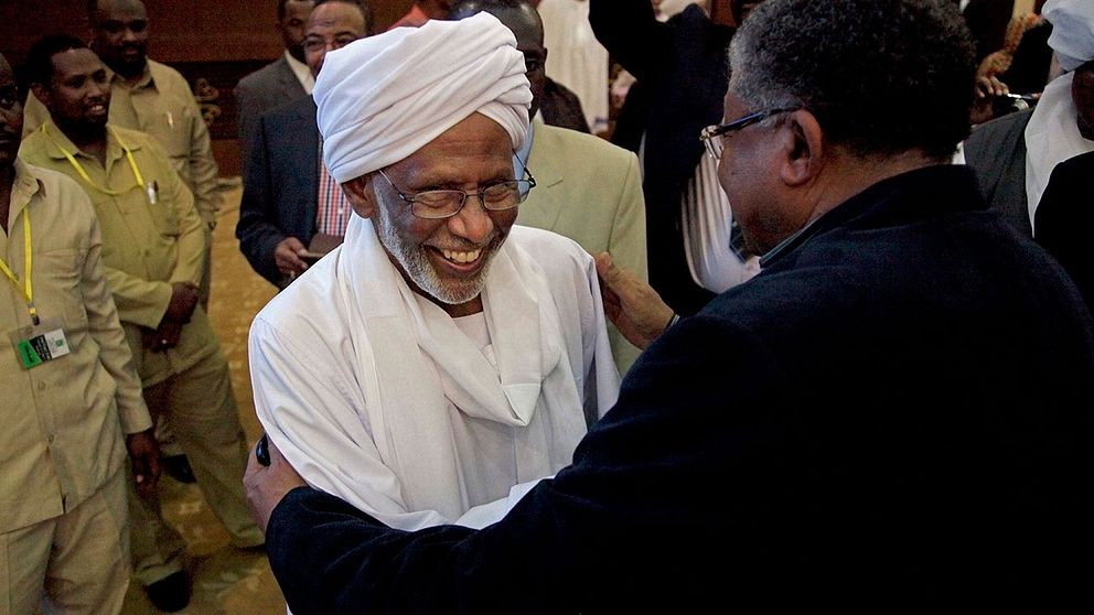 Hassan al-Turabi hälsar på presidenten Omar al-Bashir.