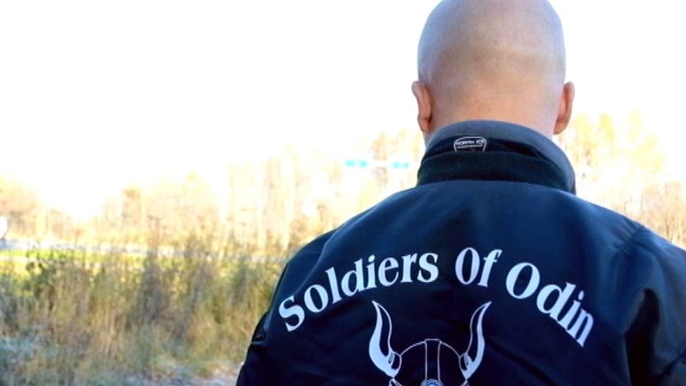 Ryggen på en man med rakat huvud som bär en jacka med texten Soldiers of Odin.