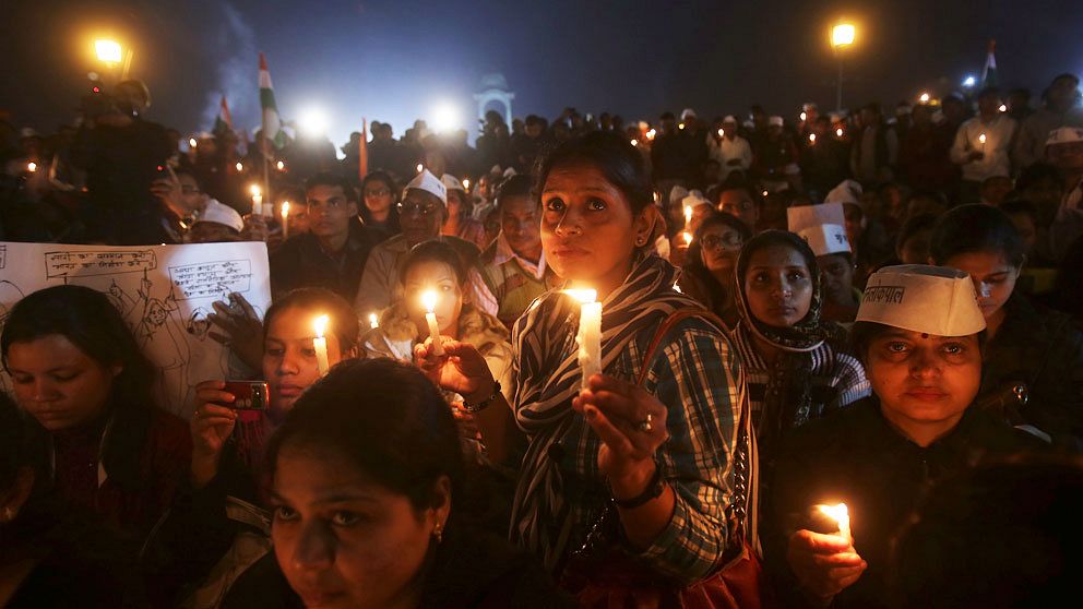Women participate in a candlelight vigil to show solidarity with a rape victim at India Gate in New Delhi December 21, 2012. Thousands of protesters took to the streets in various parts of the country to demand urgent action against the men who took turns to rape a 23-year-old woman on a moving bus on December 16, local media reports said. REUTERS/Adnan Abidi (INDIA – Tags: CRIME LAW CIVIL UNREST)