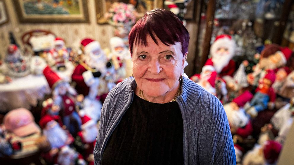 Gunbritt Pettersson i Lindome kan ha Sveriges största tomtesamling. På bilden står hon bland sina tomtar och tittar in i kameran.