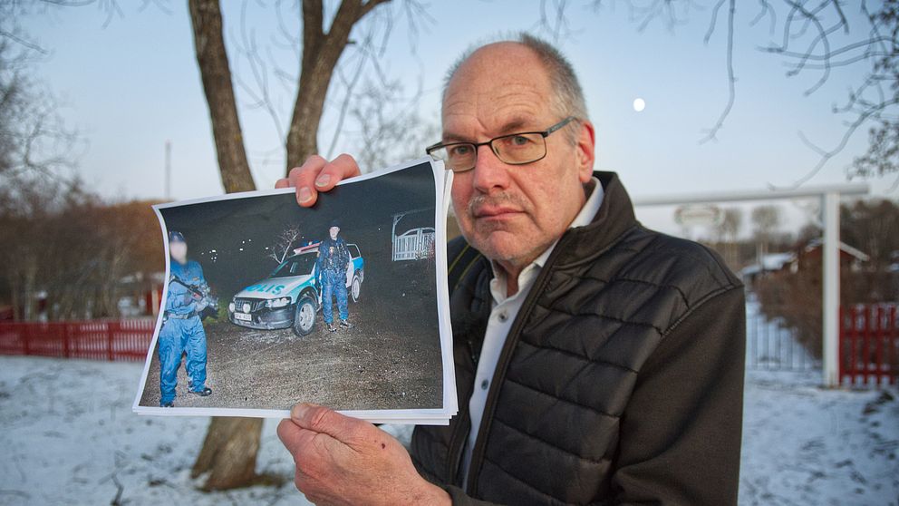 Ola Svärdhagen håller upp fotot han tog på bankrånaren.