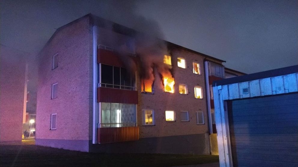 brand i flerfamiljshus i Kramfors, där lågor slår ut genom ett fönster