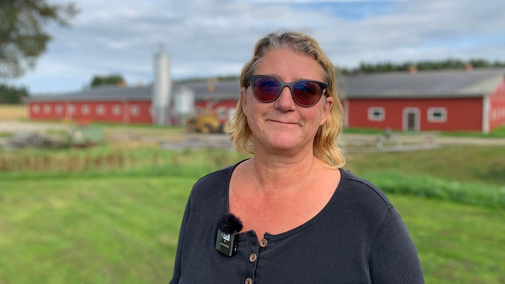 Anniqa Edström Nygård, grisbonde i Flarken, framför en ladugård
