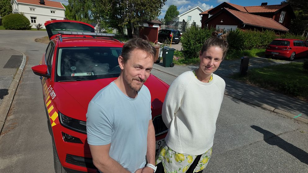 Brandmännen Jonas Segerstedt och Viktoria Aktell står framför en utryckningsbil på en gata i Kåge.