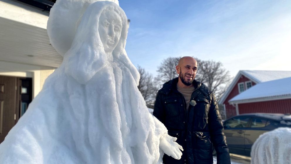 Konstnären Kamil Yacoub tillsammans med sin snöskulptur.