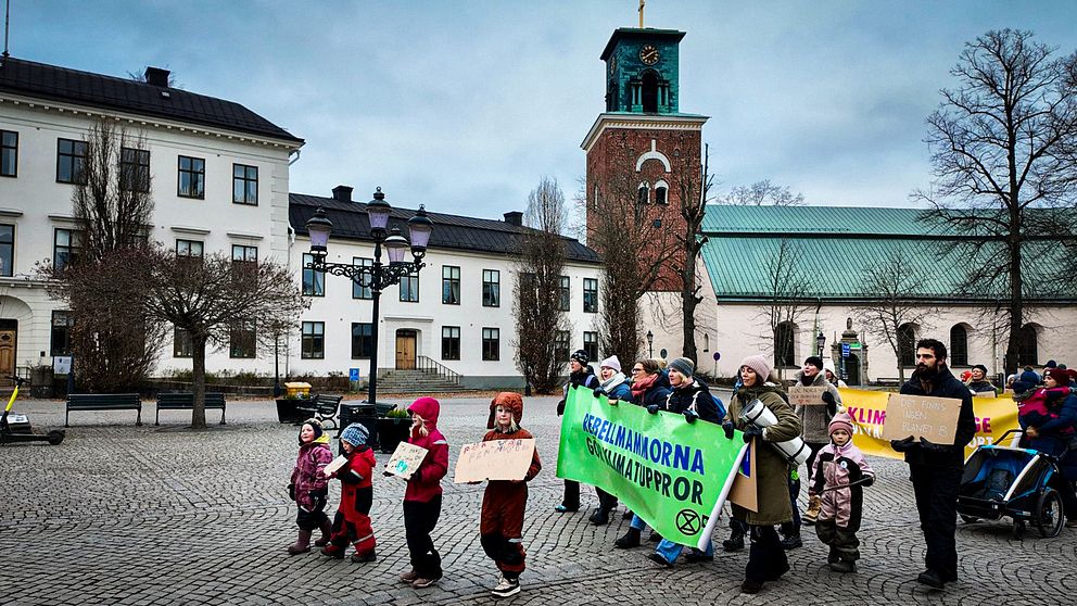 Rebellmammorna demonstrerar på ett torg i Nyköping. Längst fram några barn, sedan föräldrar med plakat