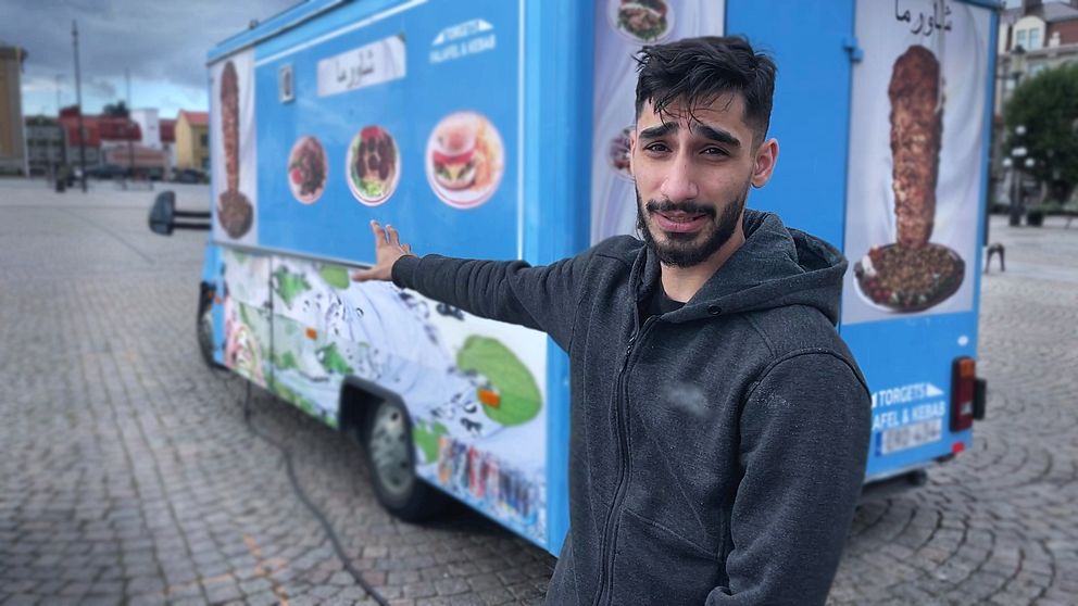 Man vid kebabvagn på torg