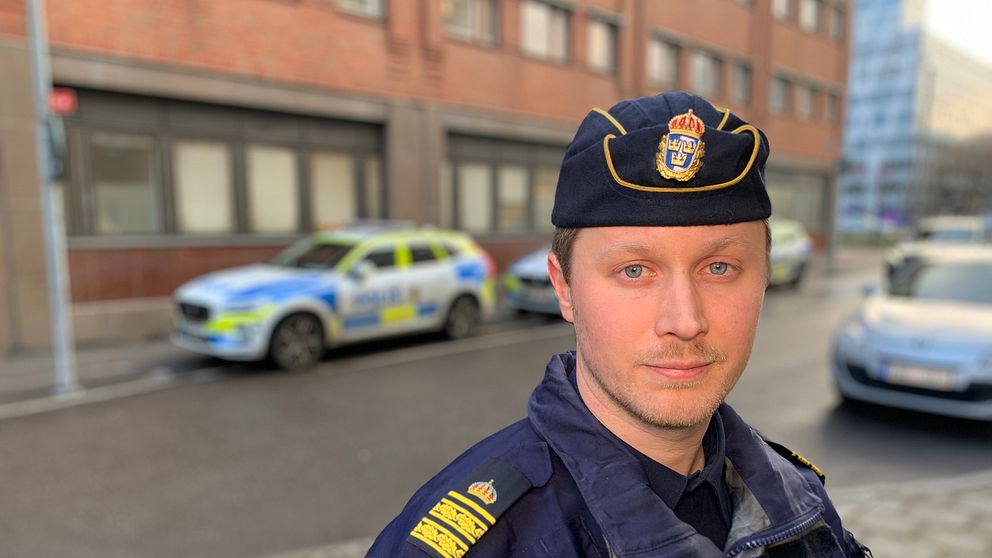 Polis framför polisbil.