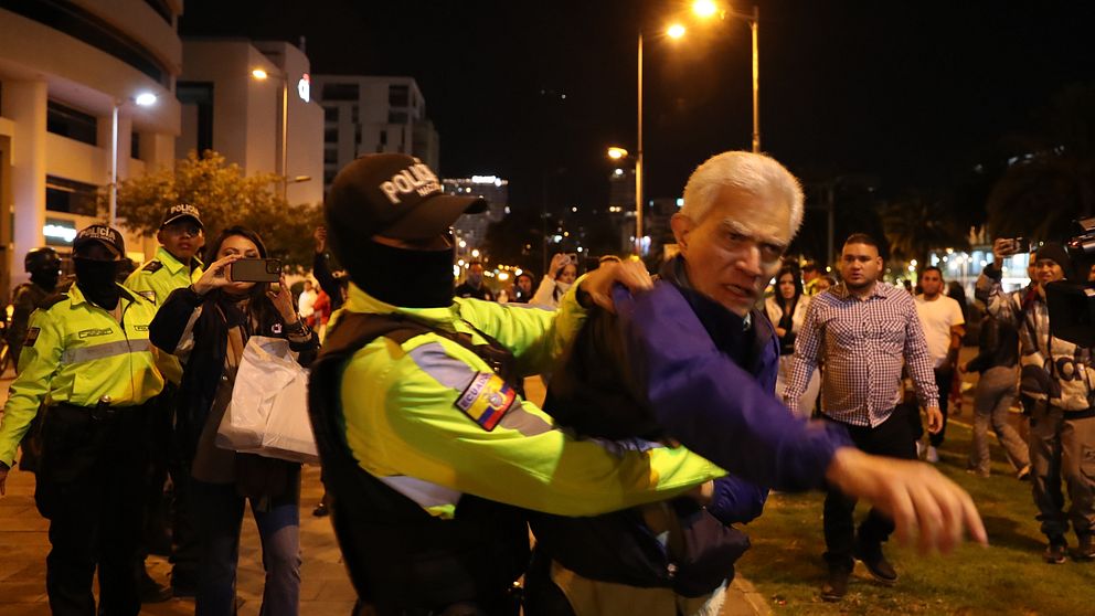 Chefen för kansliet och politiska frågor vid Mexikos ambassad, Roberto Canseco (R), kämpar mot polisen när han försöker förhindra gripandet av Ecuadors tidigare vicepresident Jorge Glas.