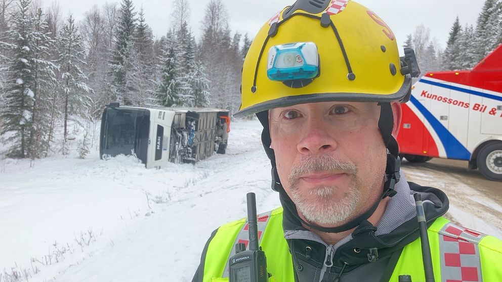 Räddningsledaren Lennart Stenman framför den omkullvälta bussen utanför Norsjö