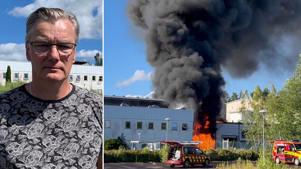 Man i glasögon framför fabrik, lågor från brand