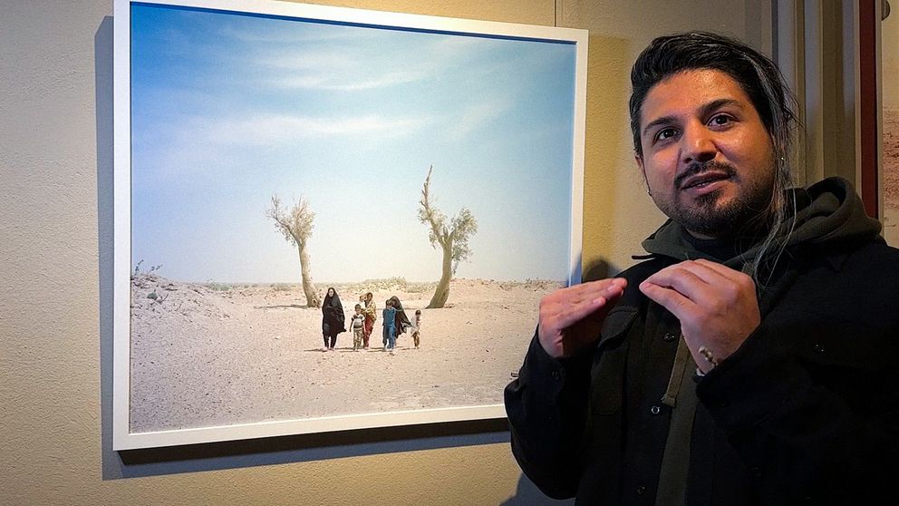 Fotografen Hashem Shakeri visar en av sina bilder från utställningen