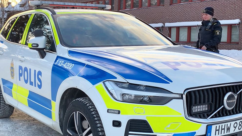 Polis som går mot en polisbil utanför Sollefteås polishus.