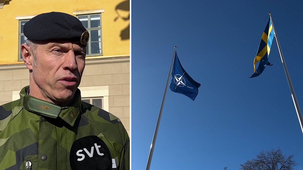En major i basker framför gul byggnad och en Natoflagga och en svensk flagga framför rådhuset i Kristinehamn