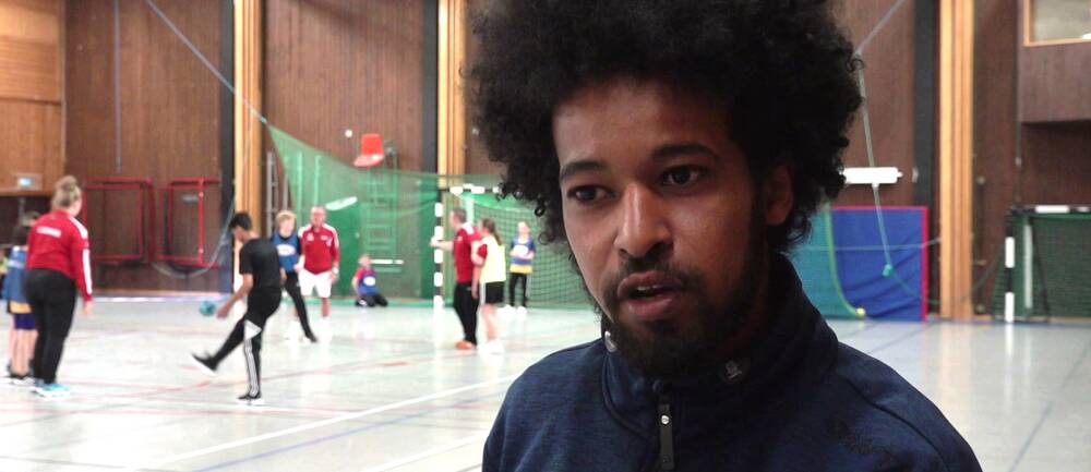 idrottskonsulenten Mousa Mousa i en sporthall där ungdomar tränar handboll