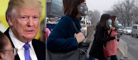 Kvinnor med masker mot den dåliga luften i Kina och en bild på Donald Trump.