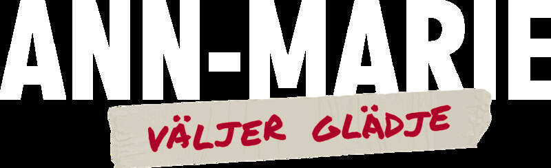 En vit bakgrund med en bit papper där det står Väljer glädje skrivet i röd färg. Logotyp för Ann-Marie väljer glädje.