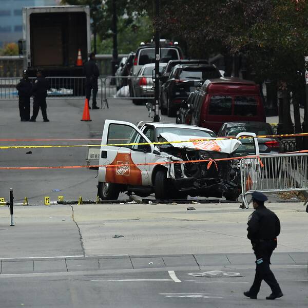 A police offier walks past the wreckage of a Home Depot pickup truck, a day after it was used in an terror attack, in New York on November 1, 2017. The pickup truck driver who plowed down a New York cycle path, killing eight people, in the city's worst attack since September 11, was associated with the Islamic State group but ”radicalized domestically,” the state's governor said Wednesday. The driver, identified as Uzbek national named Sayfullo Saipov was shot by police in the stomach at the end of the rampage, but he was expected to survive. / AFP PHOTO / Jewel SAMAD
