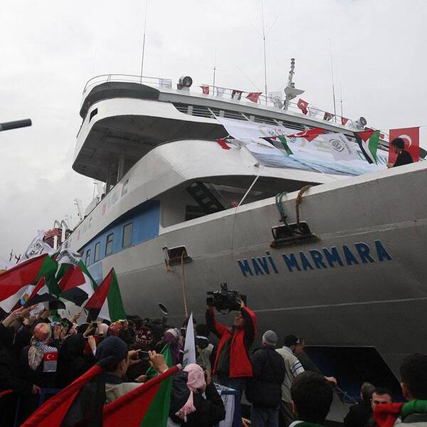 In this Sunday, Dec. 26, 2010 file photo, people holding Turkish and Palestinian flags cheer as the Mavi Marmara ship, the lead boat of a flotilla headed to the Gaza Strip which was stormed by Israeli naval commandos in a predawn confrontation in the Mediterranean on May 31, 2010, arrives back in Istanbul, Turkey. Turkey said Friday Sept. 2, 2011 it was expelling the Israeli ambassador and cutting military ties with Israel over the last year's deadly raid on a Gaza-bound aid flotilla, further souring the key Mideast relationship between Turkey and Israel.(AP Photo/Burhan Ozbilici, File)