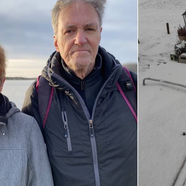 Två personer som tittar in i kameran. Till höger en grav med metalllock och vält sten.
