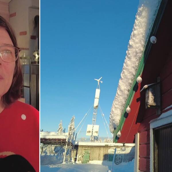 En kvinna iklädd röd tröja med en pingvin på är inne i en stuga och håller i ved.