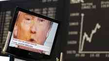 A TV screen showing U.S. President-elect Donald Trump is pictured in front of the German share price index, DAX board, at the stock exchange in Frankfurt, Germany, November 9, 2016. REUTERS/Staff/Remote