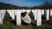 A woman reacts over a relative's grave at the memorial centre of Potocari near Srebrenica on November 22, 2017. United Nations judges on November 22, 2017 sentenced former Bosnian Serbian commander Ratko Mladic to life imprisonment after finding him guilty of genocide and war crimes in the brutal Balkans conflicts over two decades ago. / AFP PHOTO / Dimitar DILKOFF
