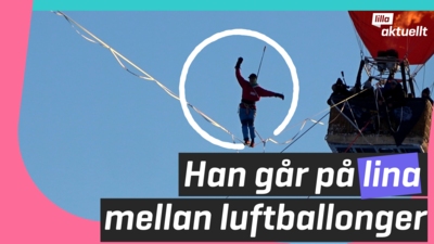 Han går på lina mellan luftballonger