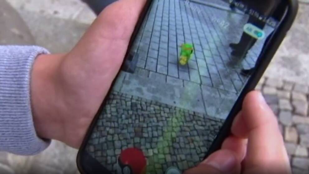 Närbild på en mobiltelefon med spelet Pokémon GO igång.