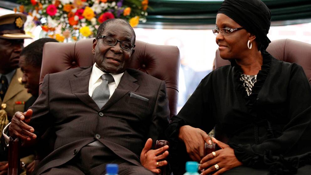 FILE PHOTO: Zimbabwe President Robert Mugabe (L) speaks to his wife Grace during the funeral of his sister, Bridget in the village of Zvimba, Zimbabwe January 21 2014. REUTERS/Philimon Bulawayo/File Photo
