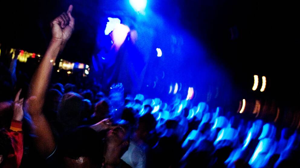 Människor som dansar och rör sig i nattklubbsmiljö.