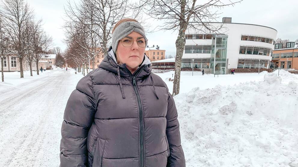 Bild på en kvinnlig student bakom Högskolan i Gävle.