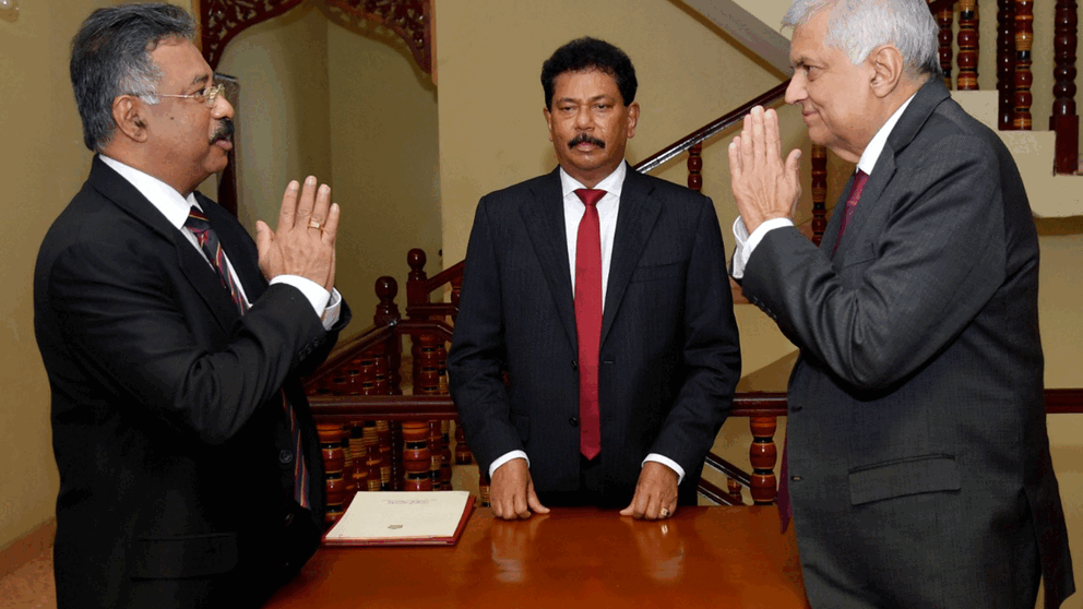 Sri Lankan Prime Minister Ranil Wickremesinghe (right) is sworn in as interim president before the country's chief legal officer Jayantha Jayasuriya (left) in the capital, Colombo.