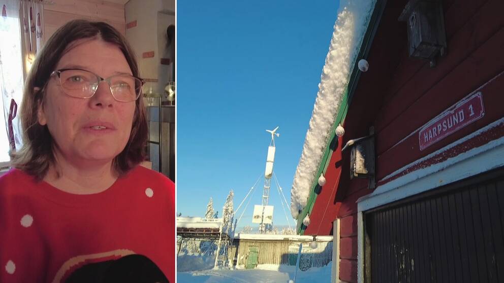 En kvinna iklädd röd tröja med en pingvin på är inne i en stuga och håller i ved.