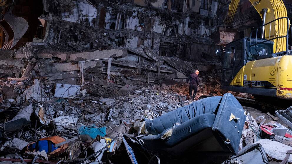 En man undersöker en förstörd byggnad i Diyarbakir i Turkiet. 