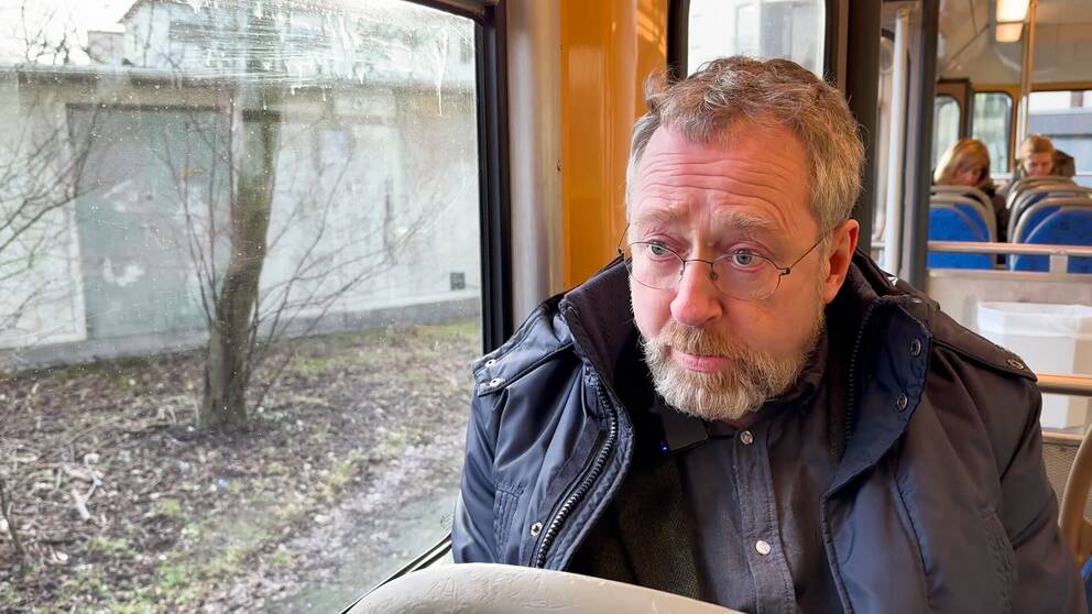 Professor Christian Munthe på bild sittandes i en spårvagn.