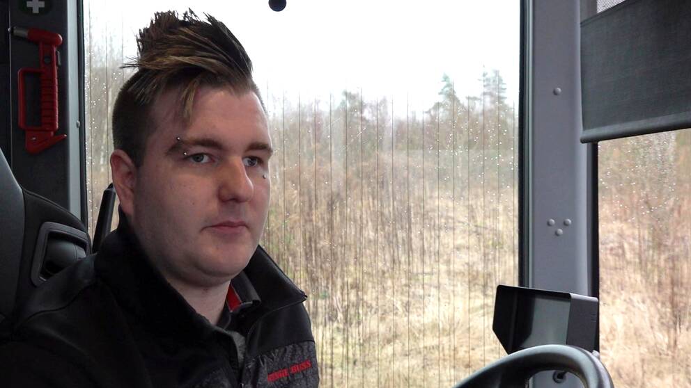 Johan Olofsson sitter bakom ratten i en bus.