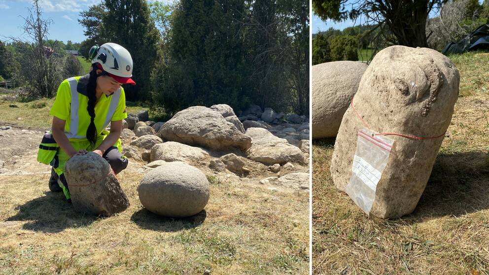 en arkeolog som står vid en sten i form av en fallossymbol.